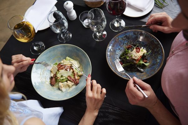 Overhead view of couple eating lunch at restaurant table